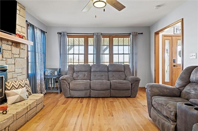 living room with light wood-type flooring and ceiling fan