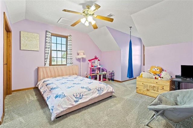 carpeted bedroom featuring visible vents, a textured ceiling, baseboards, and vaulted ceiling