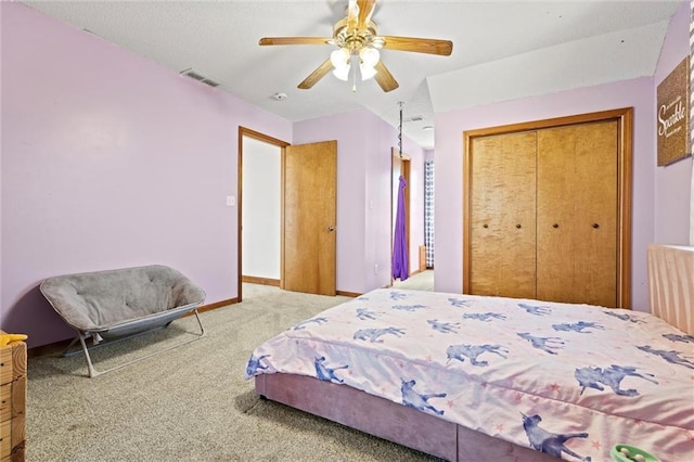 bedroom featuring visible vents, baseboards, carpet, a closet, and a ceiling fan