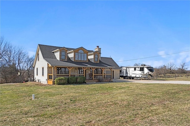 view of front facade featuring covered porch, concrete driveway, a chimney, and a front lawn