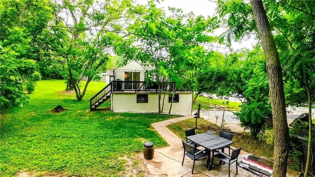 back of house with stairway, a yard, a patio area, and fence