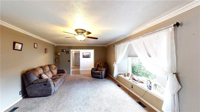 living area featuring baseboards, carpet floors, visible vents, and crown molding