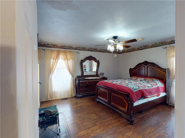 bedroom with dark wood-style floors and a ceiling fan