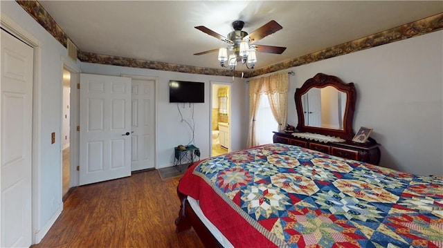 bedroom with ensuite bath, baseboards, a ceiling fan, and dark wood-type flooring