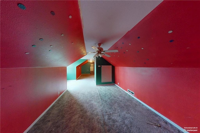 bonus room with carpet floors, lofted ceiling, visible vents, and baseboards