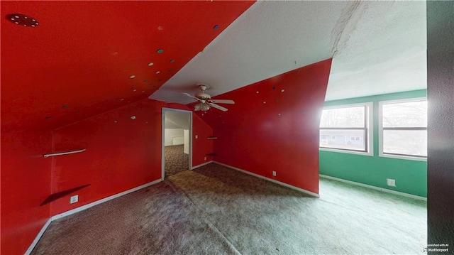 bonus room with lofted ceiling, carpet floors, ceiling fan, and baseboards