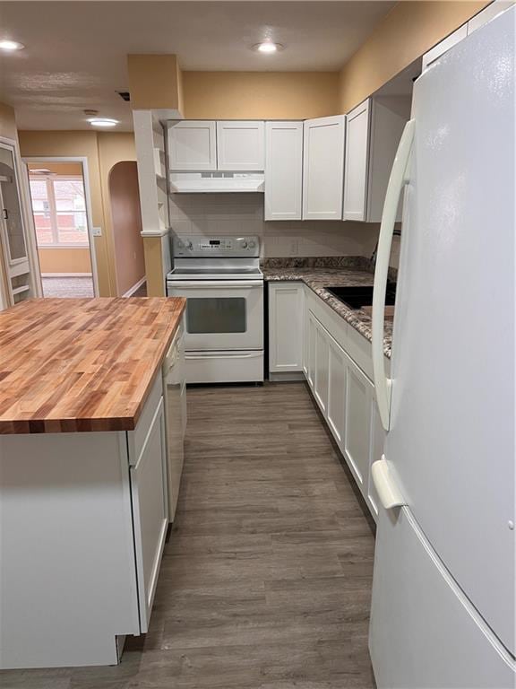 kitchen with white appliances, dark wood-style flooring, butcher block countertops, and white cabinets