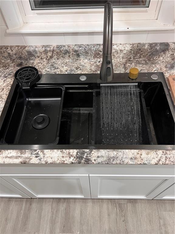 details featuring white cabinets and a sink