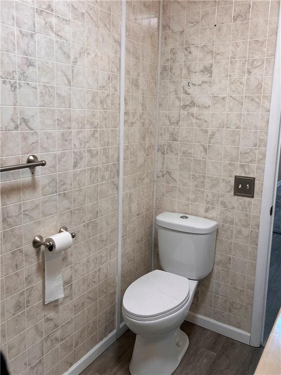 bathroom featuring wood finished floors, toilet, and baseboards