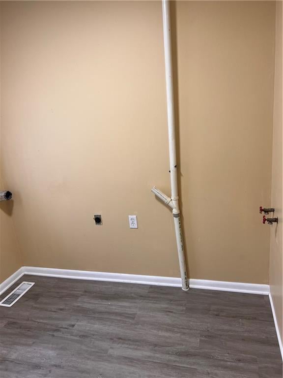 laundry room with visible vents, hookup for an electric dryer, wood finished floors, laundry area, and baseboards