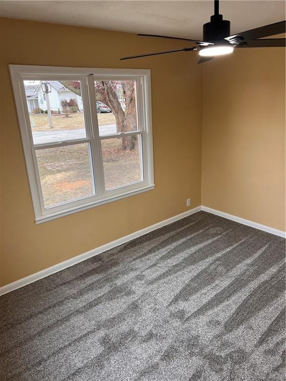 empty room with carpet, baseboards, and ceiling fan