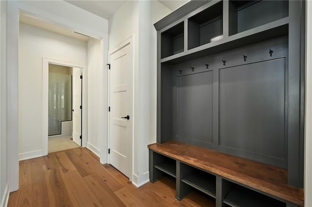 mudroom with baseboards and wood finished floors