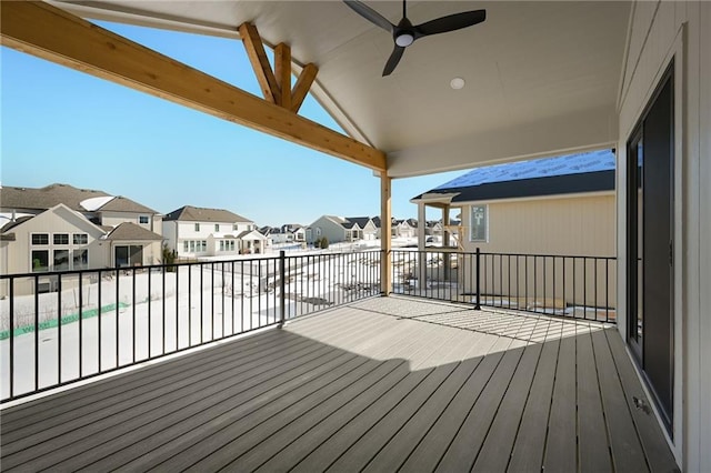 wooden deck with ceiling fan and a residential view