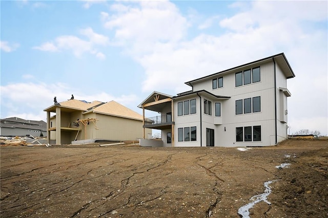 rear view of property featuring a balcony