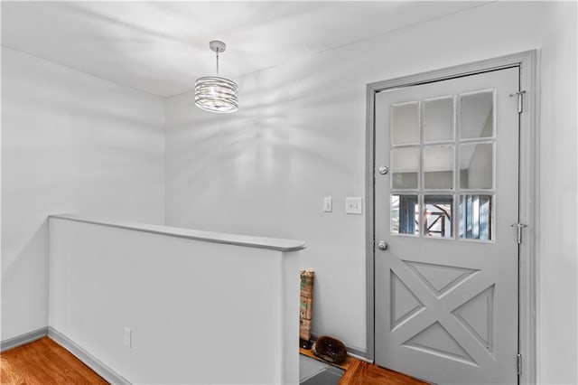 entryway with wood finished floors and baseboards