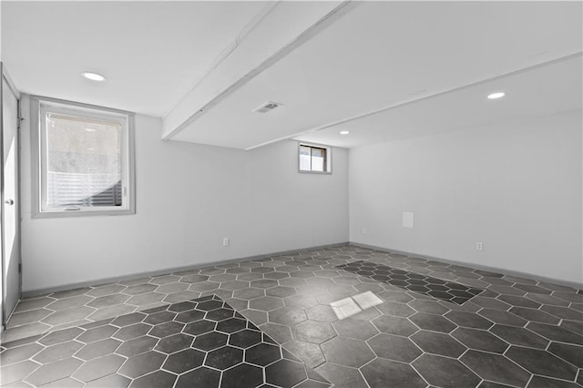 basement with baseboards, visible vents, and recessed lighting