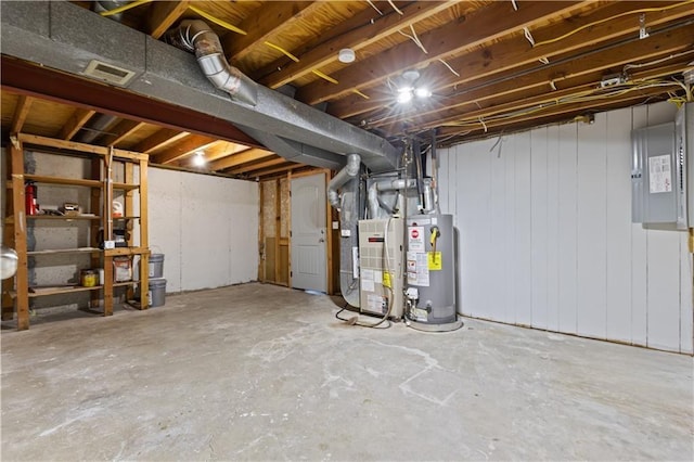 unfinished basement featuring electric panel, heating unit, and water heater