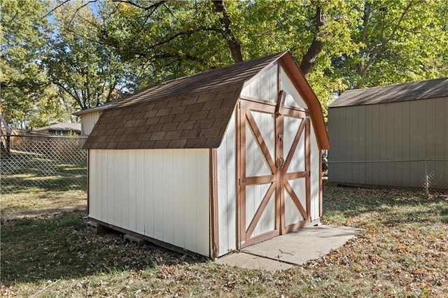 view of shed featuring fence