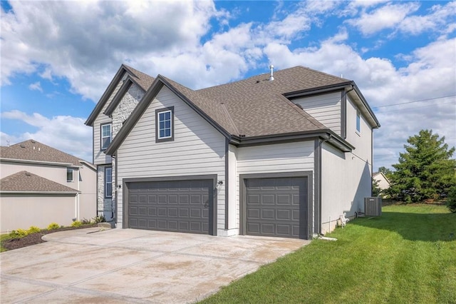 traditional home featuring a front yard, roof with shingles, driveway, and central AC