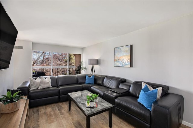 living area with wood finished floors and visible vents