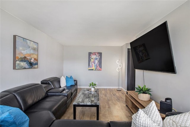 living room featuring baseboards and wood finished floors