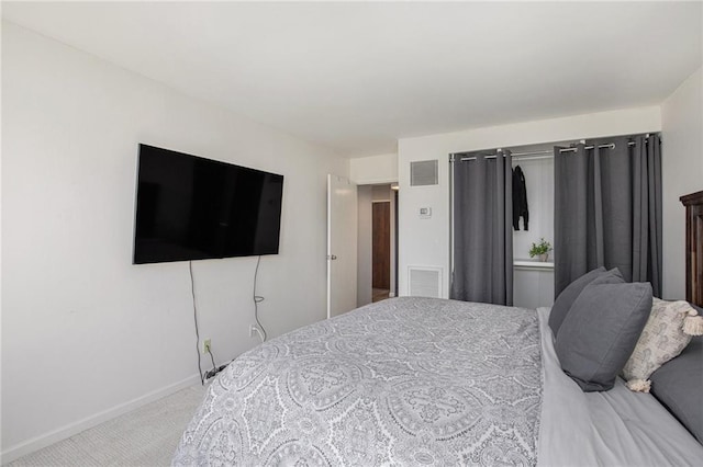 carpeted bedroom with visible vents and baseboards