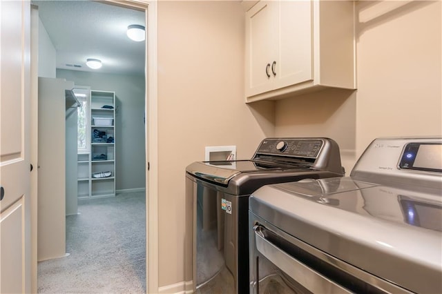 laundry room with visible vents, baseboards, washer and clothes dryer, carpet flooring, and cabinet space