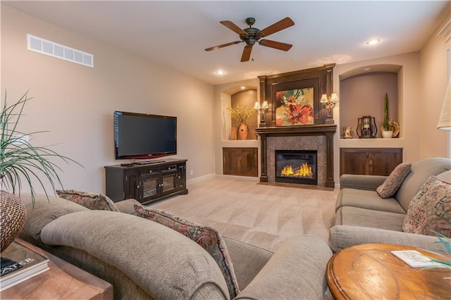 living area with carpet, visible vents, a fireplace with flush hearth, recessed lighting, and ceiling fan