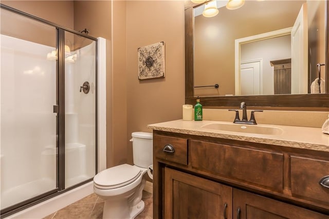 full bath with tile patterned floors, toilet, a stall shower, and vanity