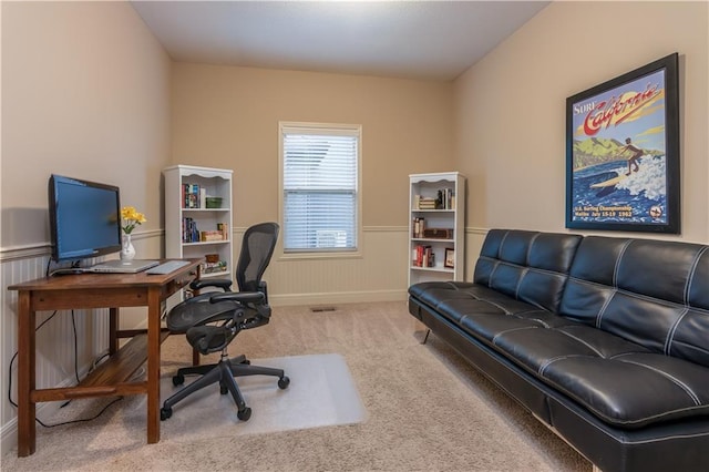 home office featuring a wainscoted wall and carpet flooring