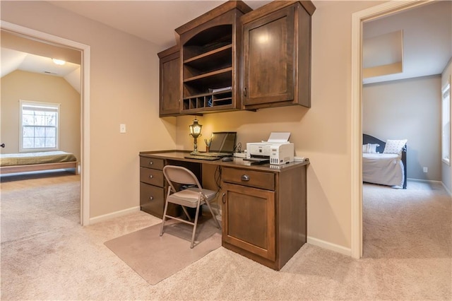 office with baseboards, light carpet, and vaulted ceiling