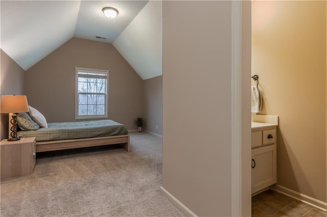 carpeted bedroom featuring visible vents, lofted ceiling, and baseboards