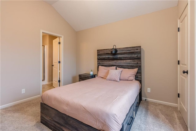 bedroom with baseboards, carpet, and lofted ceiling