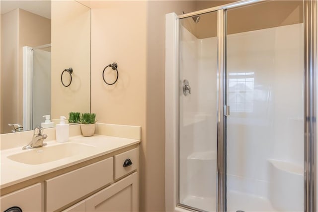 bathroom featuring vanity and a shower stall