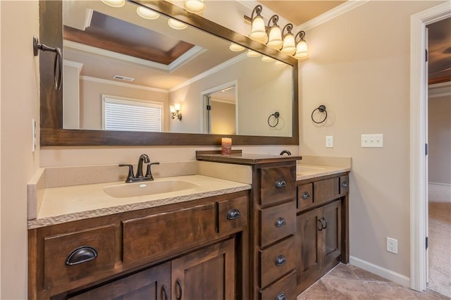 bathroom with visible vents, crown molding, double vanity, a raised ceiling, and a sink