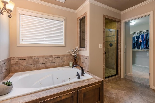 bathroom with baseboards, a whirlpool tub, a shower stall, a spacious closet, and crown molding