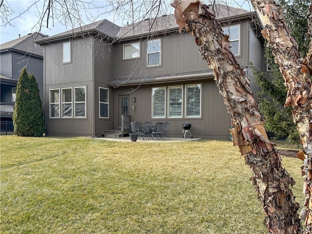 back of house featuring a patio and a yard