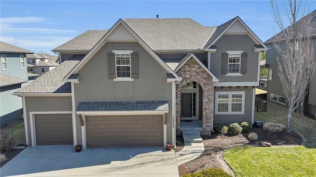 view of front facade featuring stone siding, stucco siding, driveway, and a shingled roof