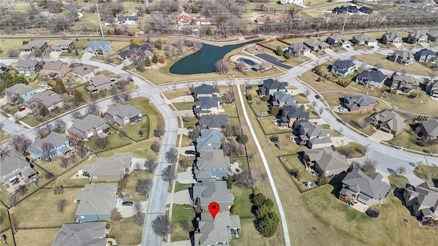 drone / aerial view featuring a residential view and a water view