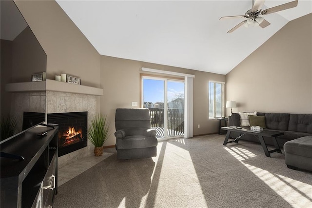 carpeted living room featuring ceiling fan, a tile fireplace, high vaulted ceiling, and baseboards