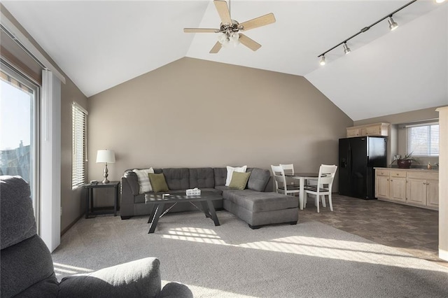 living room featuring lofted ceiling, a ceiling fan, light carpet, and track lighting