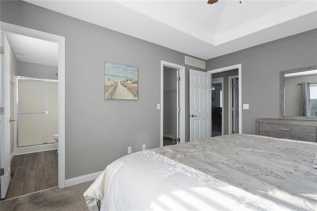 carpeted bedroom with visible vents, a ceiling fan, connected bathroom, baseboards, and a spacious closet