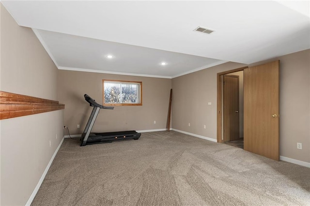 workout area with visible vents, crown molding, baseboards, and carpet floors