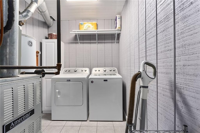 clothes washing area featuring light tile patterned floors, laundry area, and washing machine and dryer