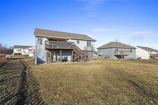 back of property featuring a deck, stairway, and a yard