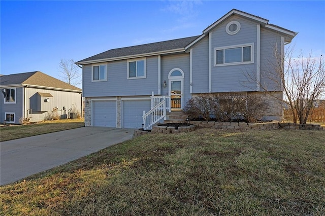 split foyer home with a garage, driveway, and a front yard