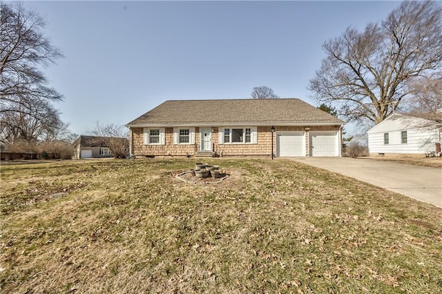 ranch-style house featuring a garage, concrete driveway, and a front yard