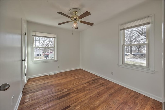 unfurnished bedroom with ceiling fan, baseboards, and wood finished floors