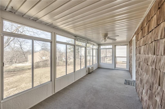 unfurnished sunroom featuring ceiling fan