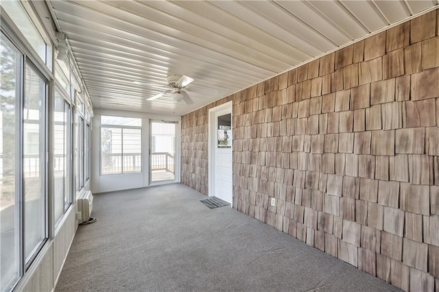 unfurnished sunroom with a healthy amount of sunlight and a ceiling fan